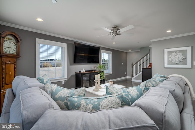 living room with crown molding, ceiling fan, wood-type flooring, and a wealth of natural light