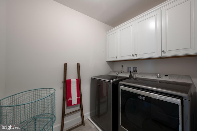 laundry room with cabinets and washer and dryer