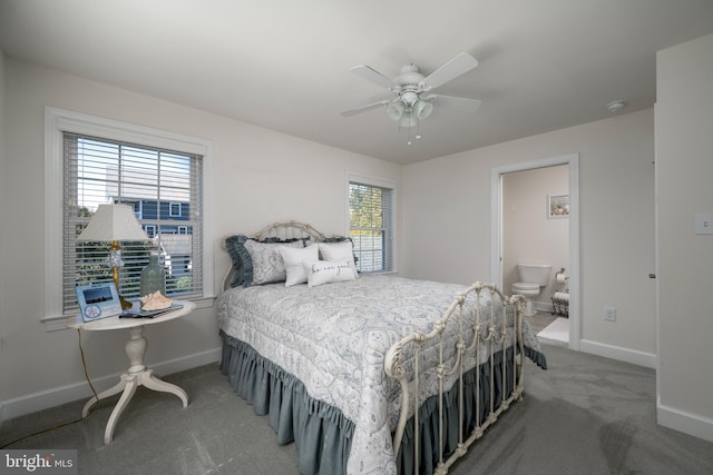 carpeted bedroom with multiple windows, ensuite bath, and ceiling fan