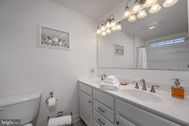 bathroom featuring vanity, toilet, and walk in shower