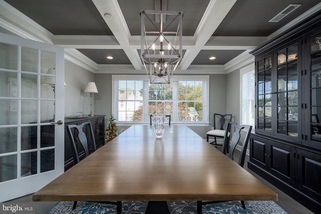 dining space with an inviting chandelier, ornamental molding, beamed ceiling, and coffered ceiling