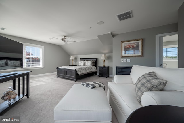 bedroom with ceiling fan, light carpet, and vaulted ceiling