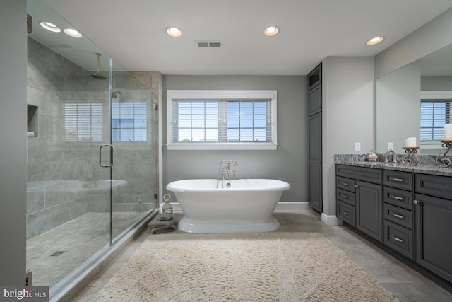 bathroom with vanity, plus walk in shower, and plenty of natural light