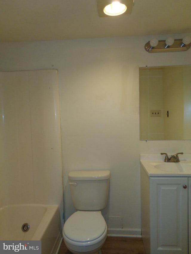 bathroom with vanity, toilet, and hardwood / wood-style flooring