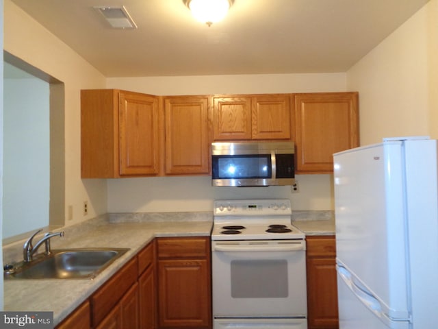 kitchen with white appliances and sink