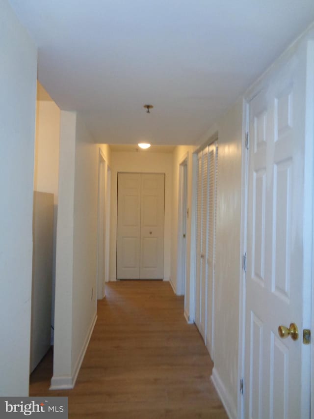 corridor featuring hardwood / wood-style floors