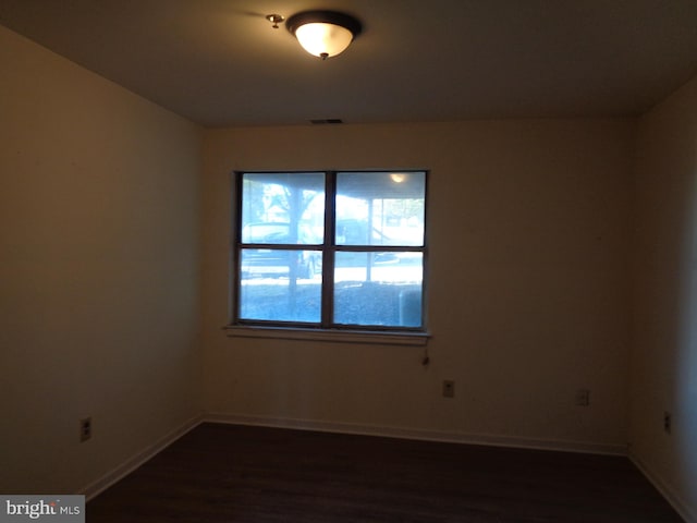 spare room featuring dark hardwood / wood-style floors