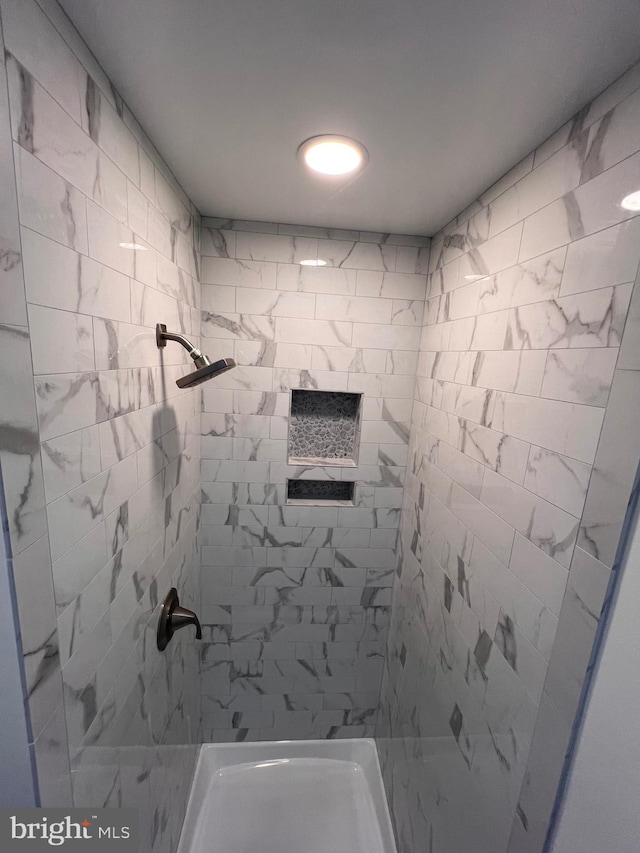 bathroom with a tile shower