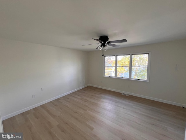 empty room with light wood-type flooring and ceiling fan