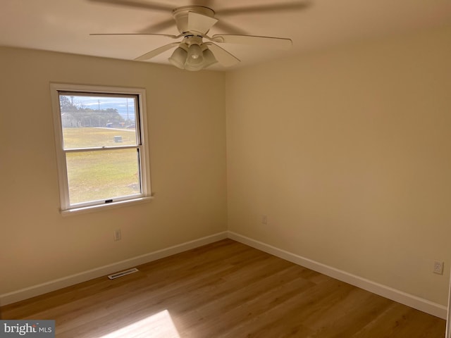 spare room featuring light hardwood / wood-style floors and ceiling fan