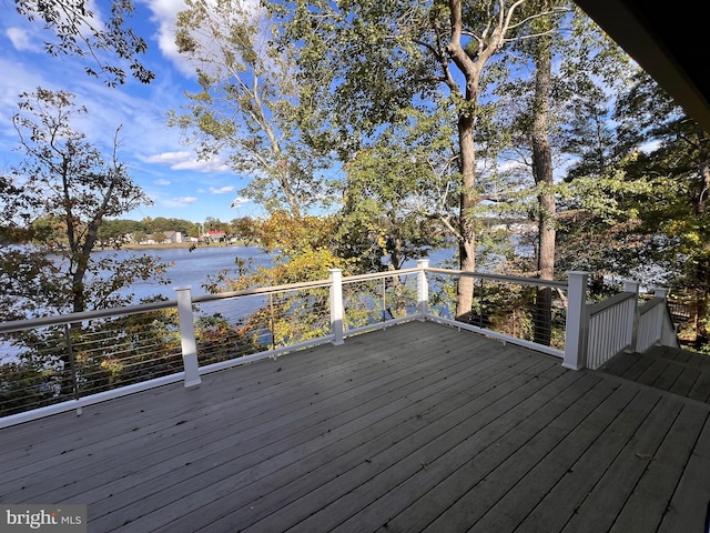 wooden terrace featuring a water view