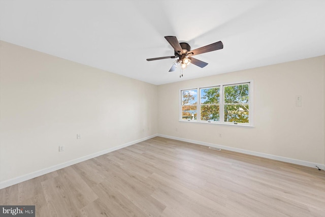 spare room featuring light hardwood / wood-style floors and ceiling fan