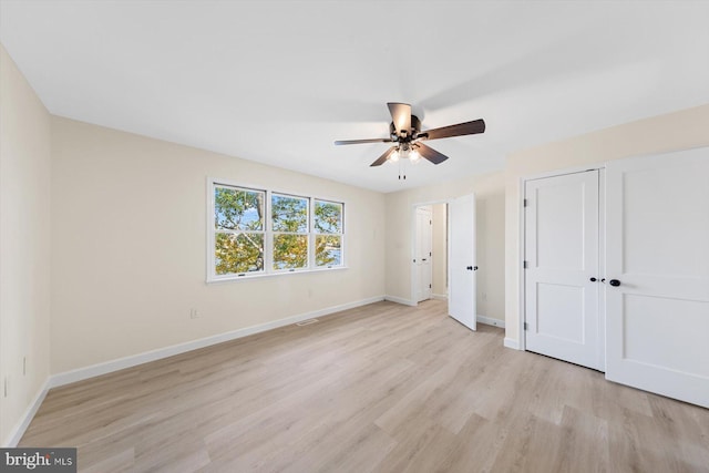 unfurnished bedroom with light hardwood / wood-style floors and ceiling fan