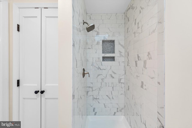 bathroom with a tile shower