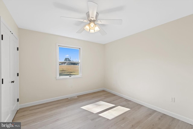 unfurnished room featuring light hardwood / wood-style flooring and ceiling fan