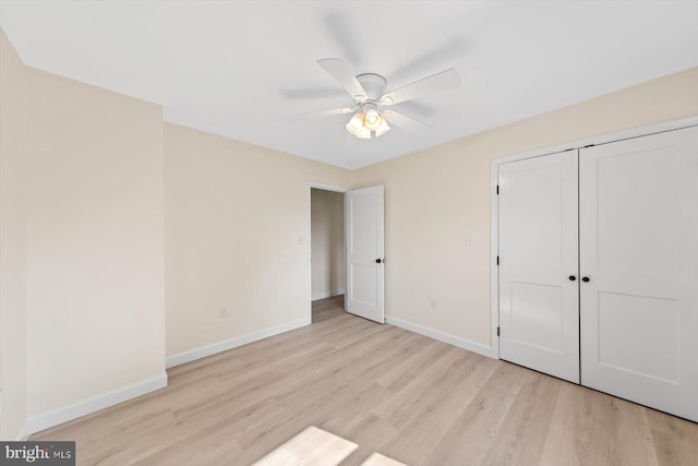 unfurnished bedroom featuring light hardwood / wood-style flooring, a closet, and ceiling fan