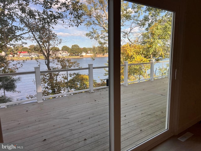 interior space featuring a wealth of natural light and a water view