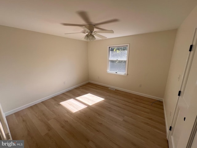 empty room featuring ceiling fan and light wood-type flooring