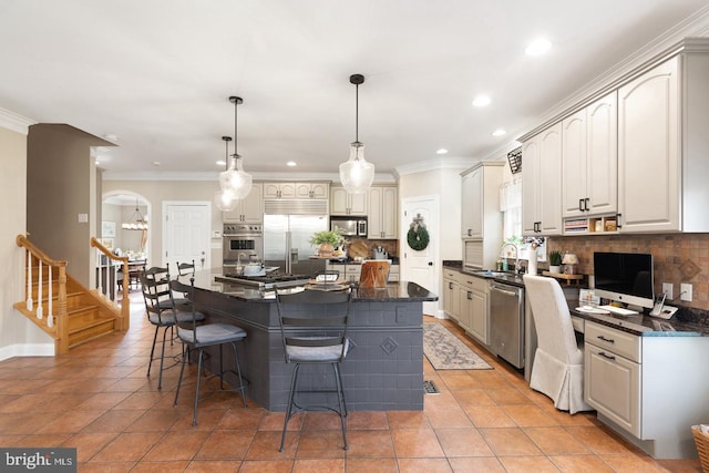 kitchen with pendant lighting, a center island, stainless steel appliances, and tasteful backsplash