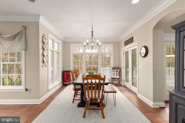 tiled dining space featuring french doors, an inviting chandelier, and plenty of natural light