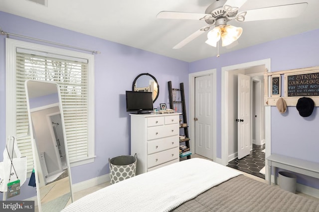 tiled bedroom featuring ceiling fan