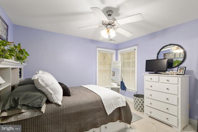 bedroom featuring light colored carpet and ceiling fan