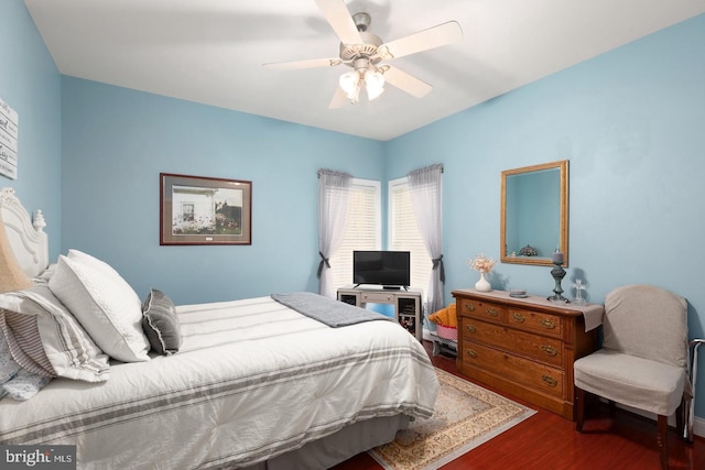 bedroom with ceiling fan and dark wood-type flooring