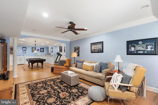 living room featuring wood-type flooring, ornate columns, crown molding, and billiards