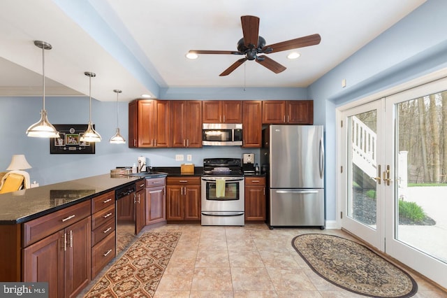 kitchen with hanging light fixtures, french doors, dark stone counters, and stainless steel appliances