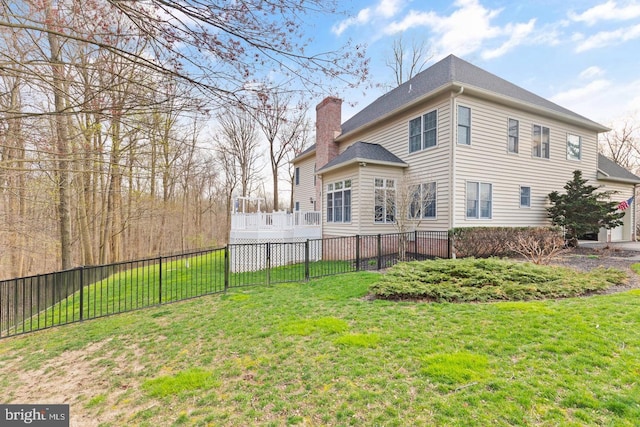 rear view of house with a yard