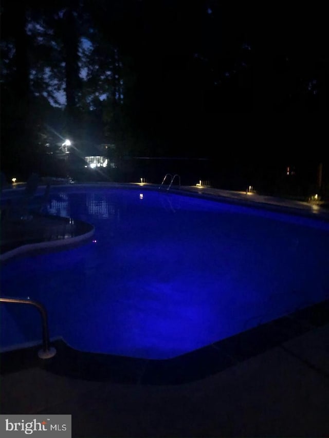 view of pool at night