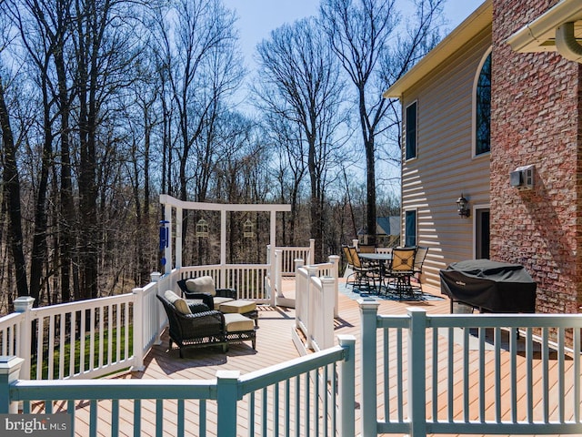 deck featuring an outdoor hangout area and grilling area