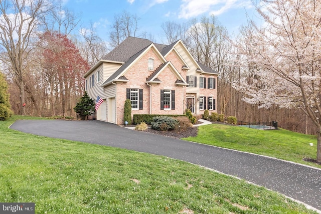 view of front facade featuring a garage and a front lawn