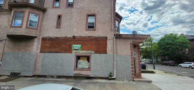 view of side of property featuring stucco siding