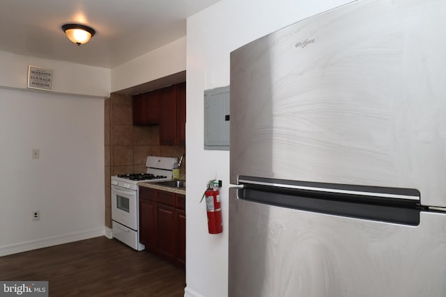 kitchen featuring electric panel, stainless steel refrigerator, white gas range, decorative backsplash, and dark hardwood / wood-style floors