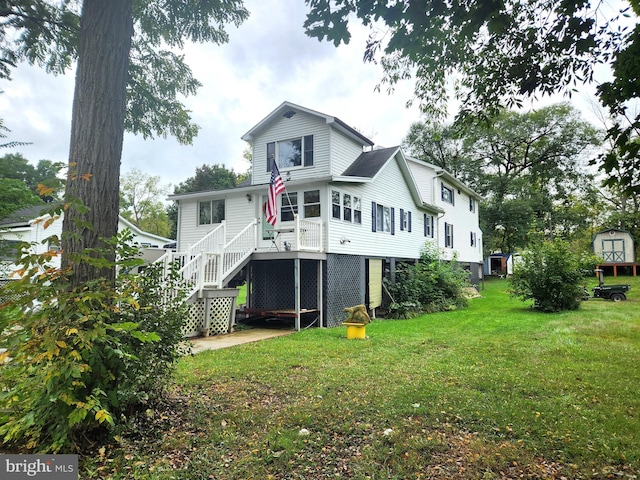 rear view of house featuring a yard