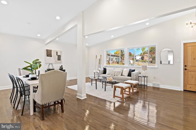 dining room with dark wood-type flooring, beam ceiling, and high vaulted ceiling