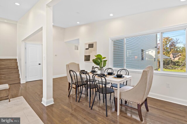 dining space with dark hardwood / wood-style floors