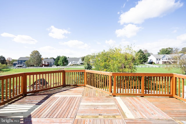 wooden deck featuring a yard