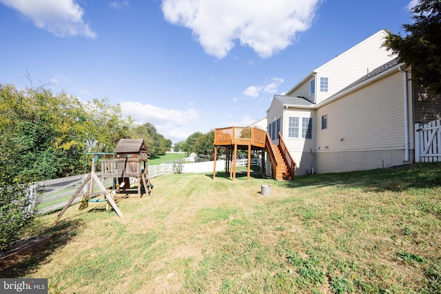 view of yard with a playground and a wooden deck