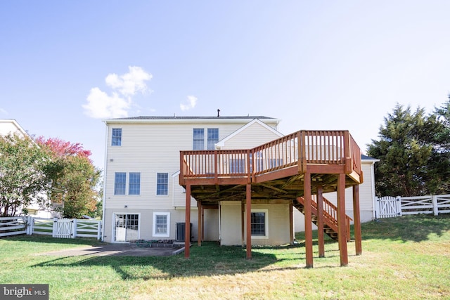 rear view of house with a lawn and a deck