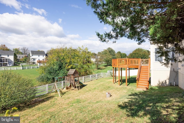 view of yard with a playground and a wooden deck