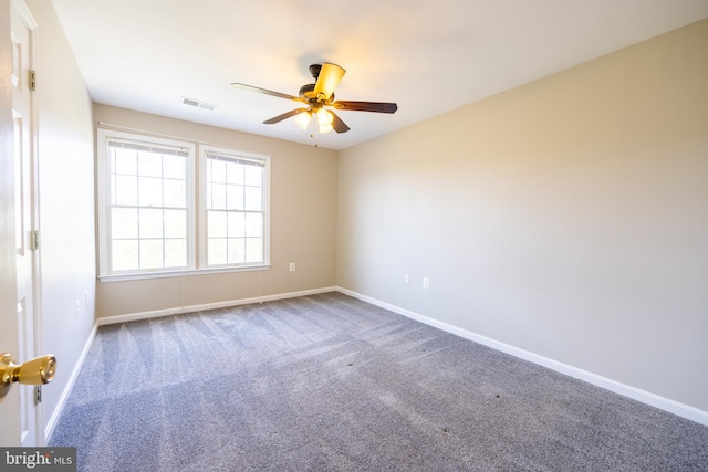 carpeted spare room featuring ceiling fan