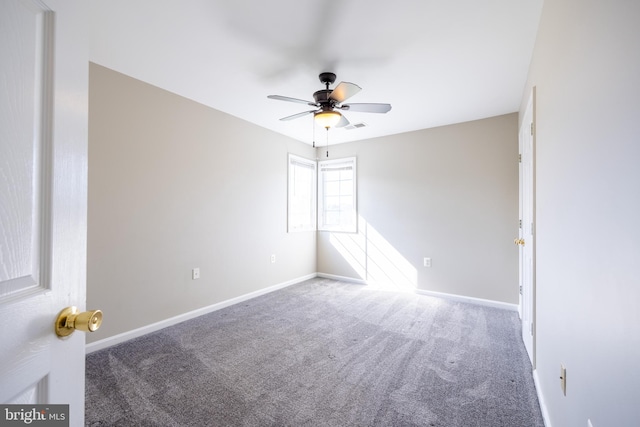 unfurnished room with ceiling fan and carpet