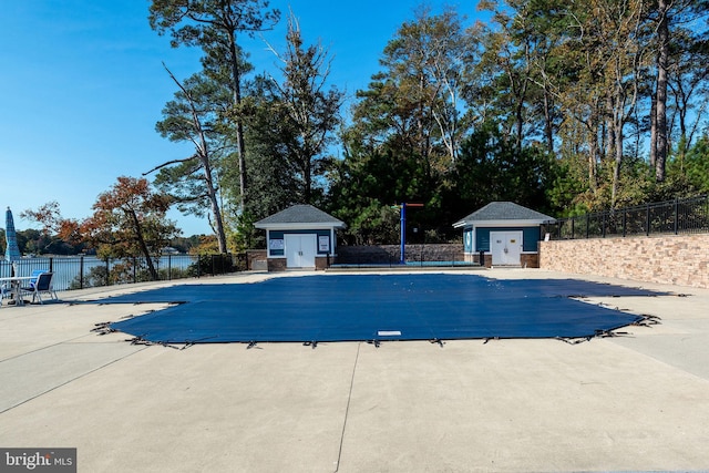 view of swimming pool with a patio area and an outdoor structure