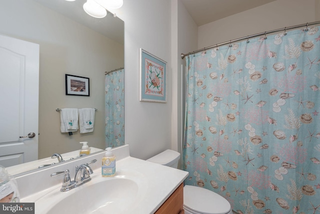 bathroom featuring toilet and vanity