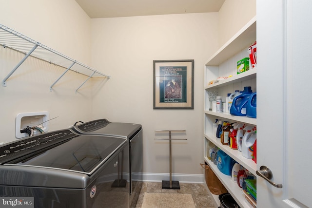 clothes washing area featuring washer and clothes dryer