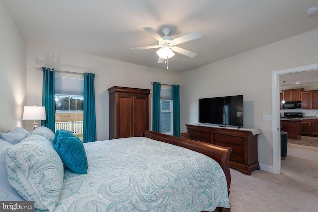 carpeted bedroom featuring access to exterior and ceiling fan