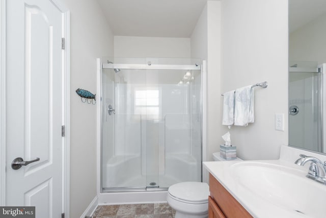 bathroom with vanity, toilet, and an enclosed shower