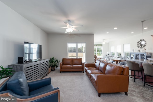 carpeted living room featuring ceiling fan